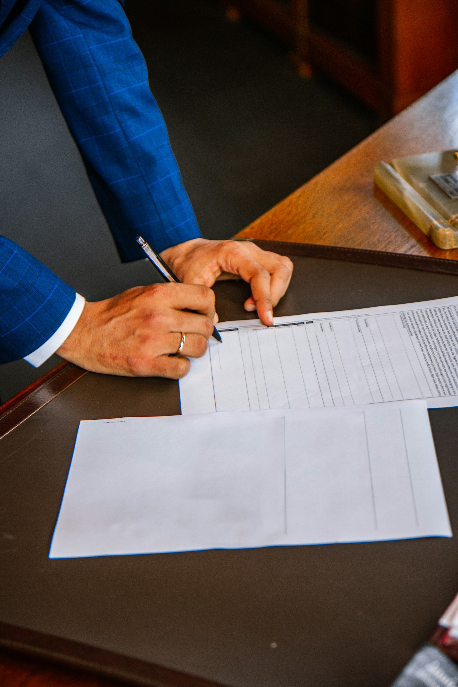 Buyer signing closing documents at a table