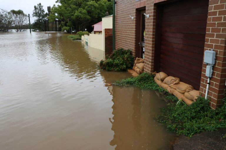 Floodwater beside a home after heavy rain