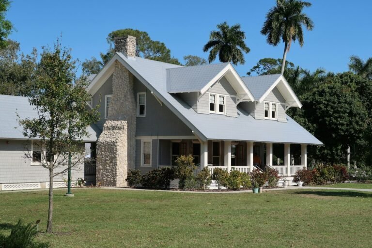 Two-story Florida home with palm trees and a green lawn