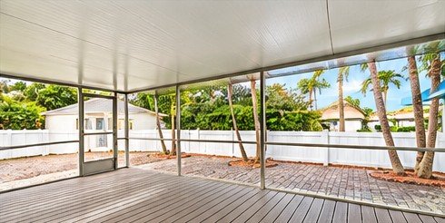 Spacious covered patio overlooking the fenced backyard
