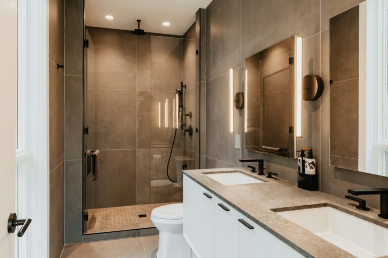 Bathroom with double sinks and a shower