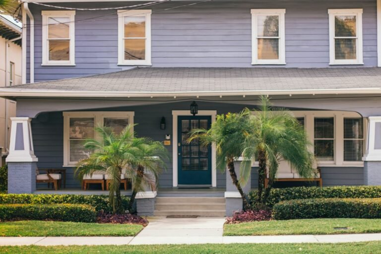 Home with a front porch and palm trees
