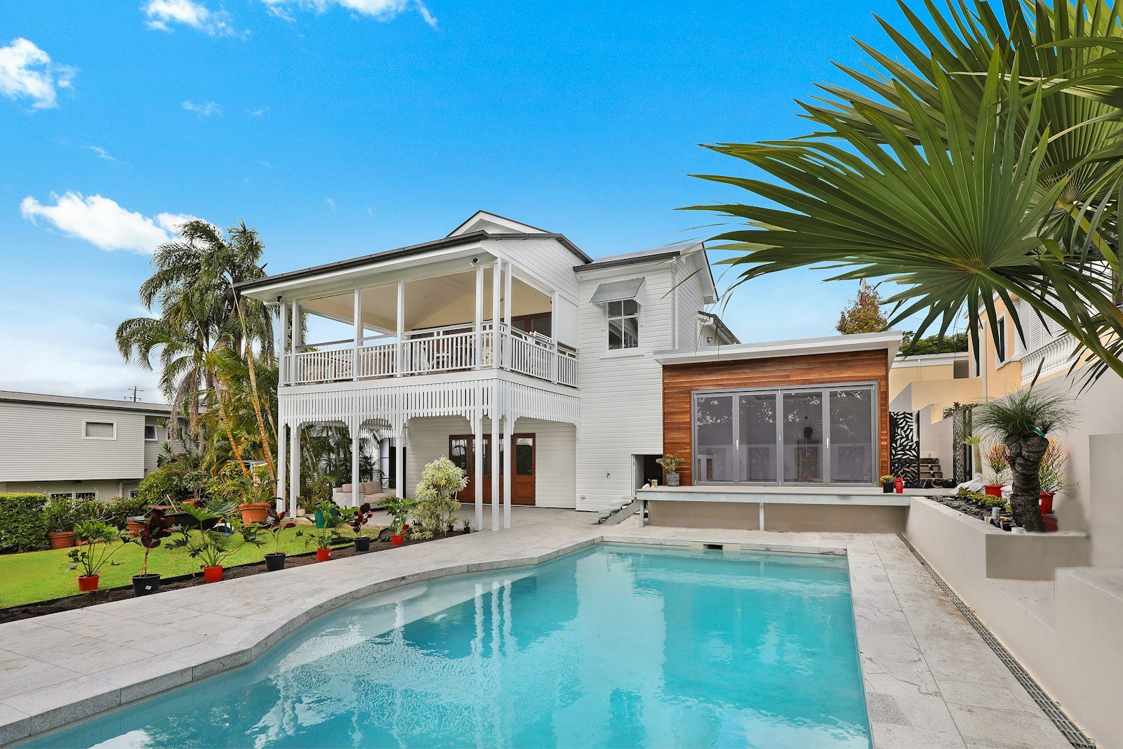 Modern home with a pool and palm trees